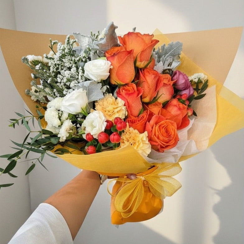 Bespoke orange rose bouquet with white roses and berries in yellow wrap, hand-held, Jiyu Florals Singapore
